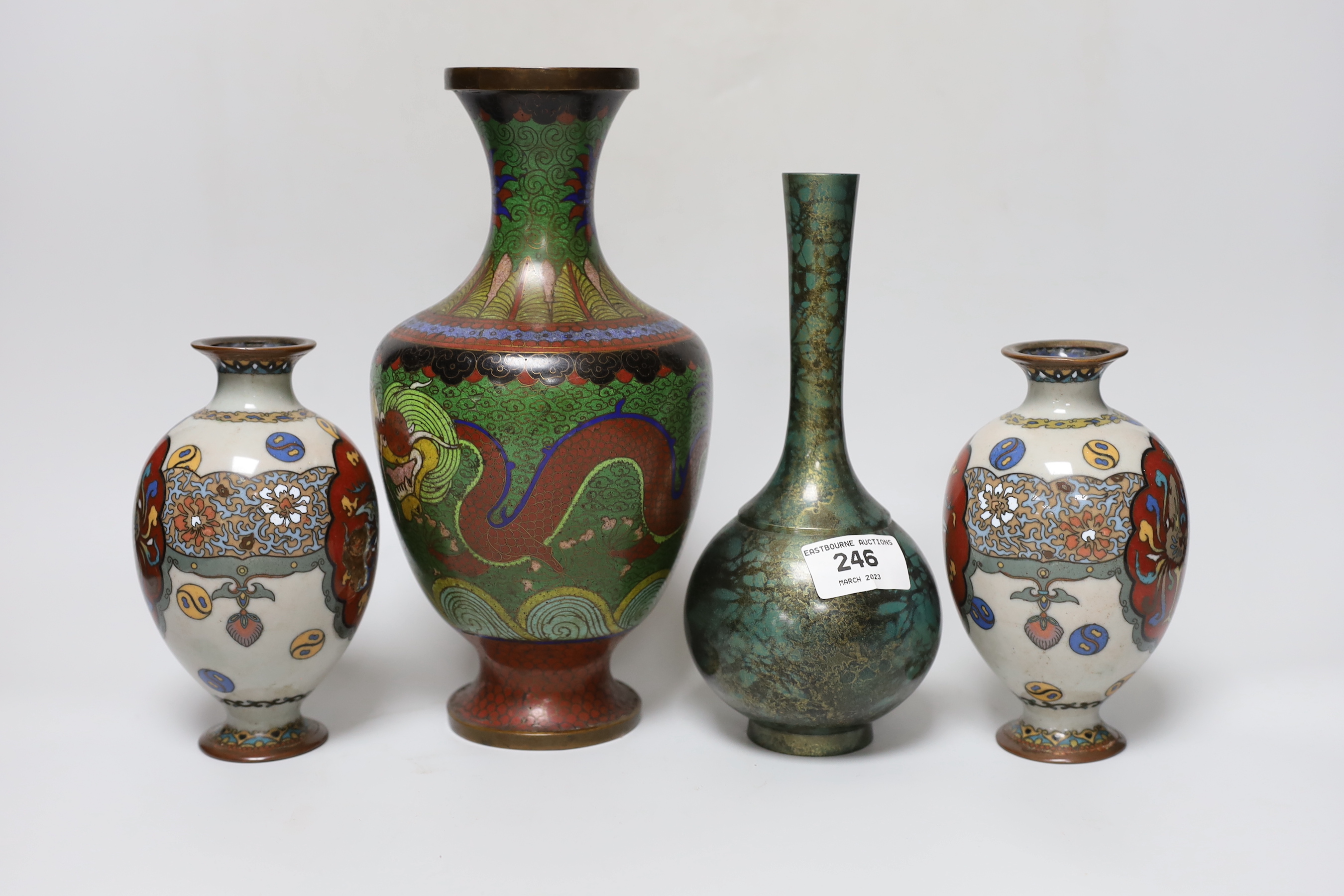 A pair of Japanese cloisonné enamel vases, a Chinese cloisonné enamel vase and a signed mottled bronze bottle vase, tallest 26cm